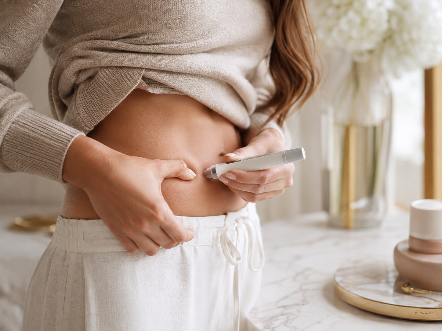 Woman using an Ozempic injection pen on her abdomen, illustrating what to eat on Ozempic for healthy weight loss and nutrition support.